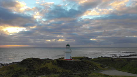 Scenic-aerial-view-of-a-lighthouse-along-the-picturesque-coast-of-New-Zealand