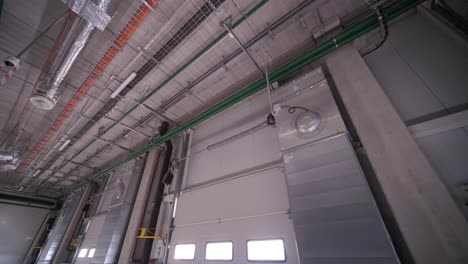 There are automatic gates at a large warehouse. The gates are used for loading cargo from large trucks.
