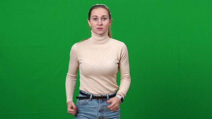 Brunette woman checking time on watch and hurrying running on green screen. Portrait of worried Caucasian lady rushing being late on chromakey background