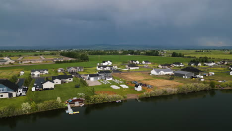 Sweeping-drone-aerial-of-a-wedding-on-a-property-on-the-shoreline-of-the-Snake-River-Idaho