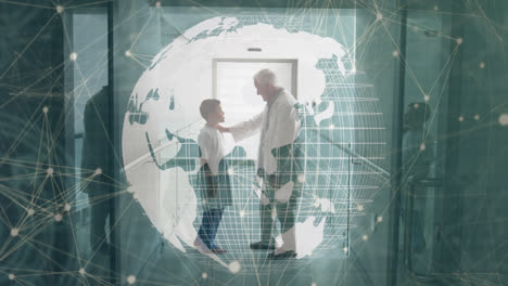 animation of globe and connections over caucasian senior doctor talking with boy