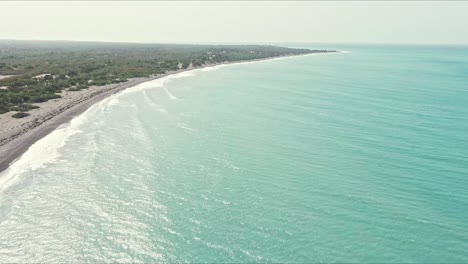 Aerial-view-overlooking-the-coastline-of-Dunas-de-las-Calderas-National-Monument-in-Dominican-Republic---pan,-drone-shot