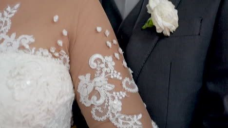 groom caressing his bride on wedding day