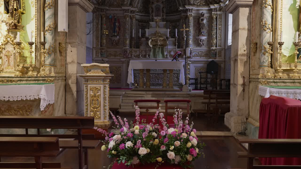 Interno di chiesa barocca con altare decorato e fiori in Portogallo