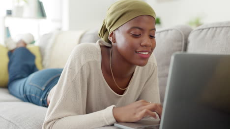 Laptop,-typing-and-black-woman-on-sofa-in-home