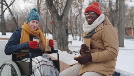 couple enjoying a coffee break in a winter park