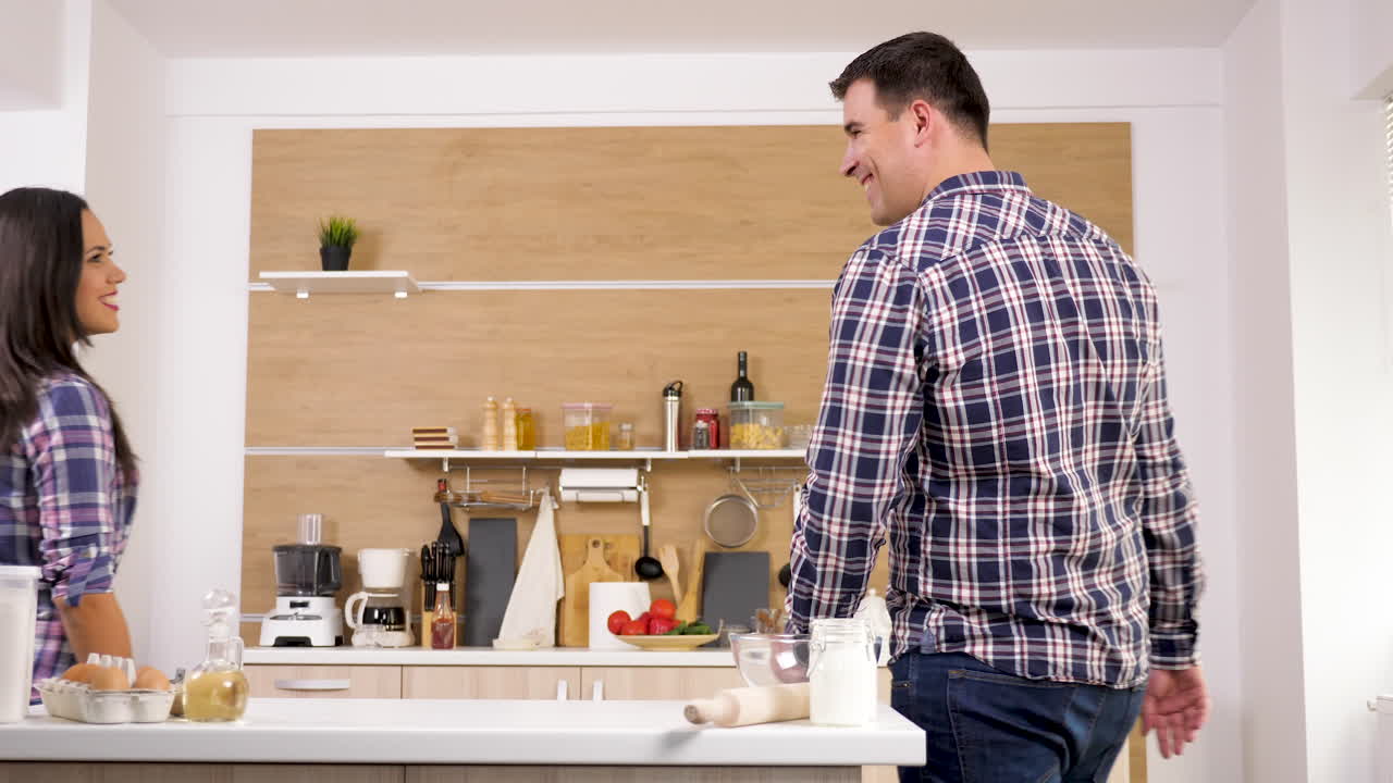 A loving couple hugging in their kitchen