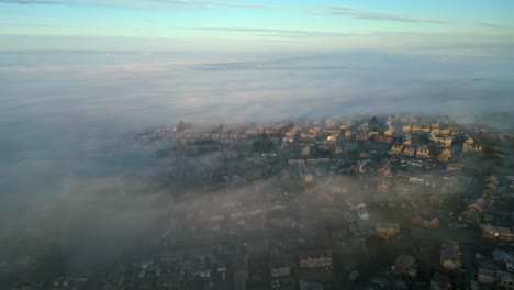 cinematic aerial footage of a misty morning, aerial shoot over small beautiful town