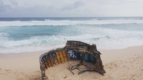 aerial view of shipwreck on beach of uluwatu, bali, indonesia. 4k drone static