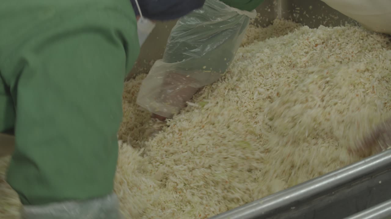 Rice factory workers processing raw uncooked rice at the factory ...