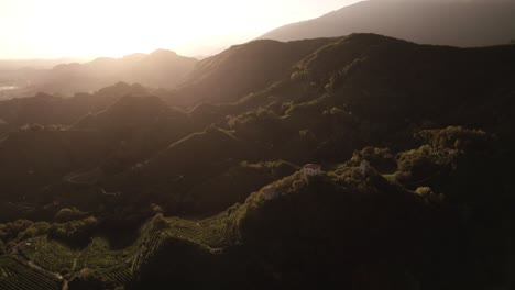 aerial panoramic landscape view of the sun setting over the famous prosecco hills with vineyard rows, in italy