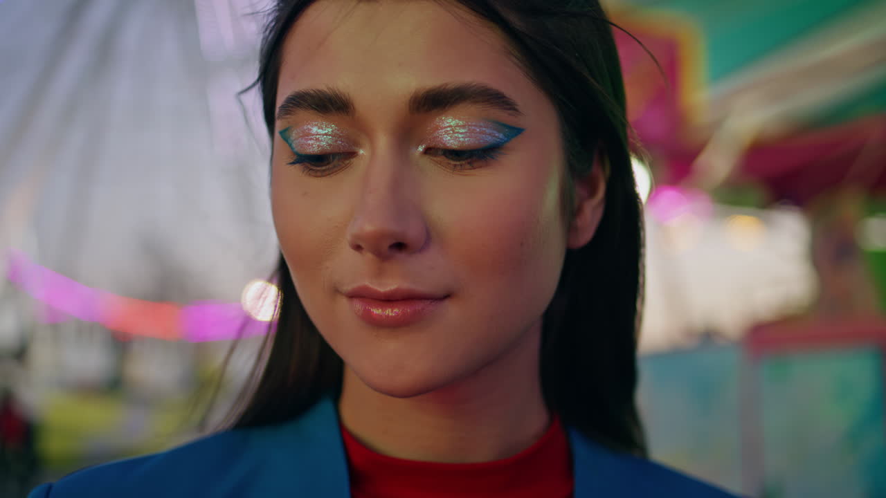 Closeup fashion beautiful girl resting illuminated amusement park at party night