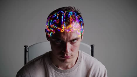 young man with glowing lines superimposed on his head, resembling a brain, sits and stares intently, conveying a concept of deep thought, artificial intelligence, or enhanced cognitive abilities