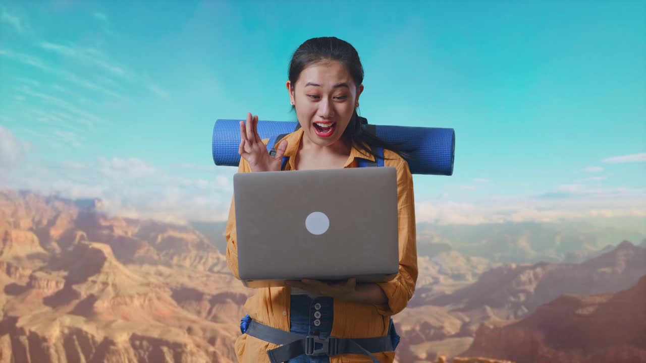 Asian Female Hiker With Mountaineering Backpack Looking At A Laptop And Saying Wow While Traveling At The Top Of Mountain