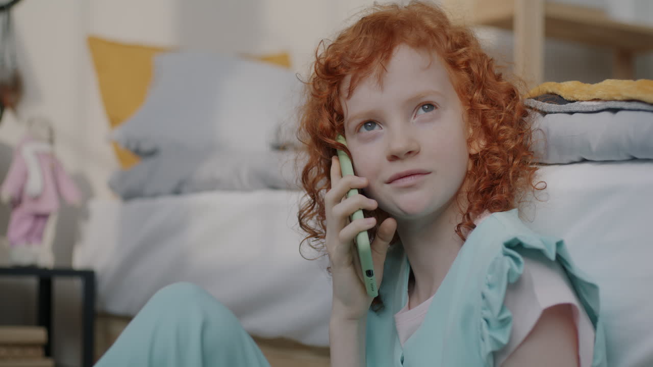 Young Girl Talking on Phone in Bedroom