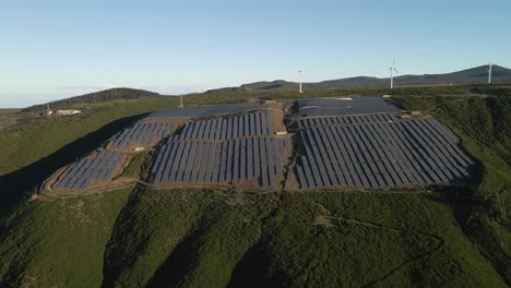 aerial view of a photovoltaic farm and a wind farm on top of a mountain in paul da serra madeira island
