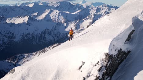 a man with skis climbs remote snowy mountains in the wild reaches of nature