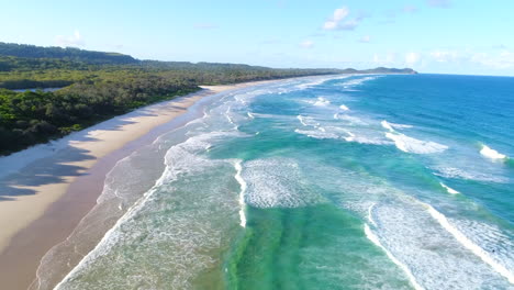 beautiful aerial shots of a beach with waves crashing