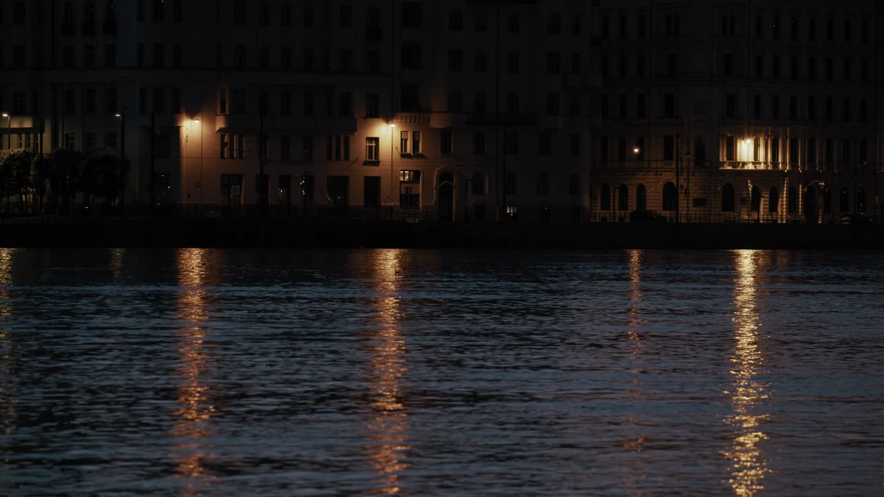 Night View of City Buildings Reflected in Calm River