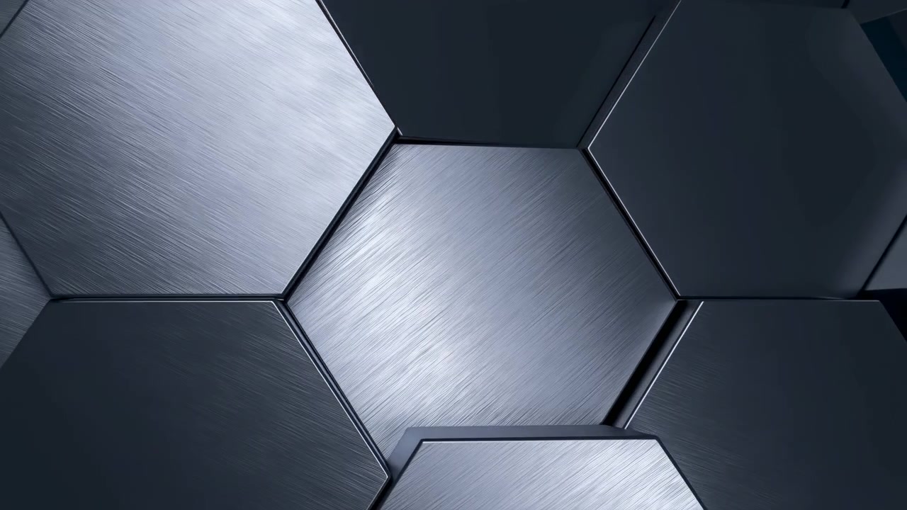Primo piano obliquo di pannelli metallici esagonali interconnessi che mostrano schemi di riflessione mutevoli mentre i riflessi speculari si muovono su superfici spazzolate e lisce, creando una geometria industriale di alta qualità.