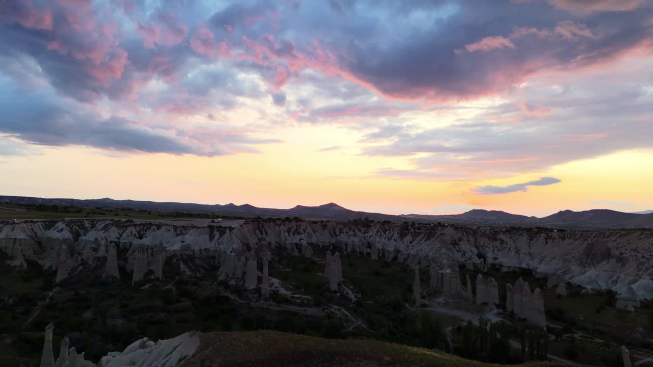 Sunset over rocky Cappadocia landscape, serene and awe-inspiring view