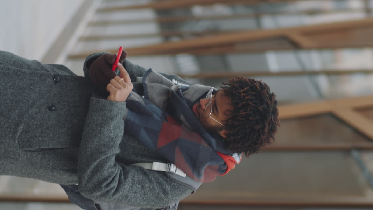 Man using smartphone outdoors in winter