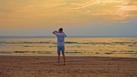 loving father circles his son by the hands, a walk on the seashore. dad is playing with his little son on the sand, they are having fun. happy fatherhood and childhood. beautiful landscape on the beach, sunset. 4k, prores