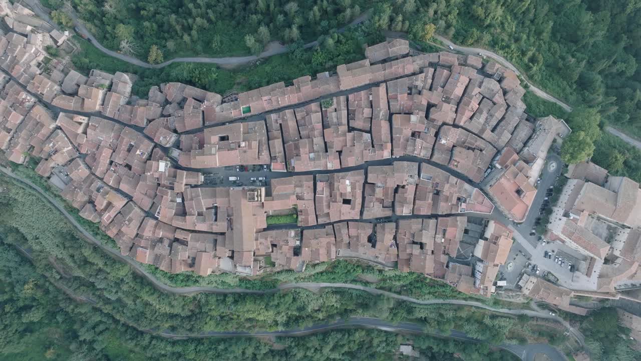 Top Down Aerial Drone view of the hilltop Medieval town of Pitigliano, Tuscany in morning light, with red tile roofs and old buildings, in 4K