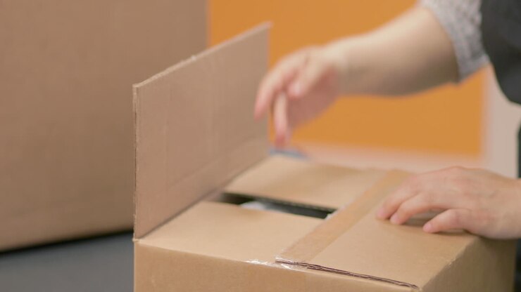 Packing a box and taping it closed to be shipped