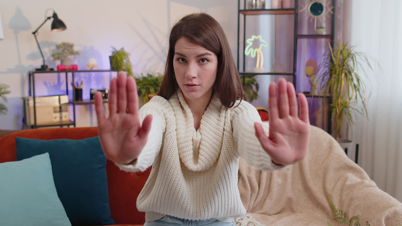 Angry woman say no hold palm folded crossed hands warning of finish stop gesture declining talk