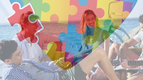 animation of colourful puzzle pieces heart over happy friends at summer beach party