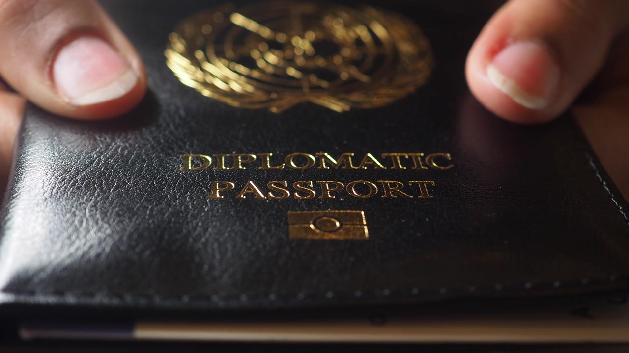 Close-Up of Hands Holding a Diplomatic Passport