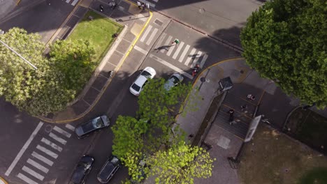 aerial top down of street juggler juggling with soccer ball on road in buenos aires