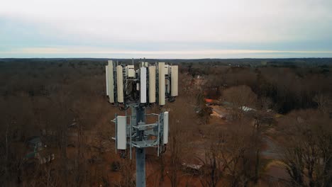 aerial shot revolving around cell phone tower in middle of forest. 4k drone footage