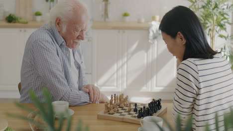 grandparent and grandchild playing chess