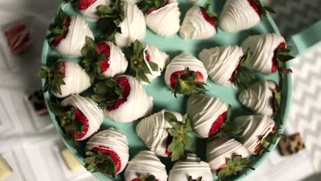 slow motion circulating shot of white chocolate covered strawberries