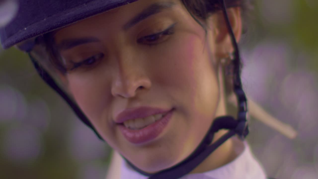 Brazilian female jockey in close up wearing riding helmet