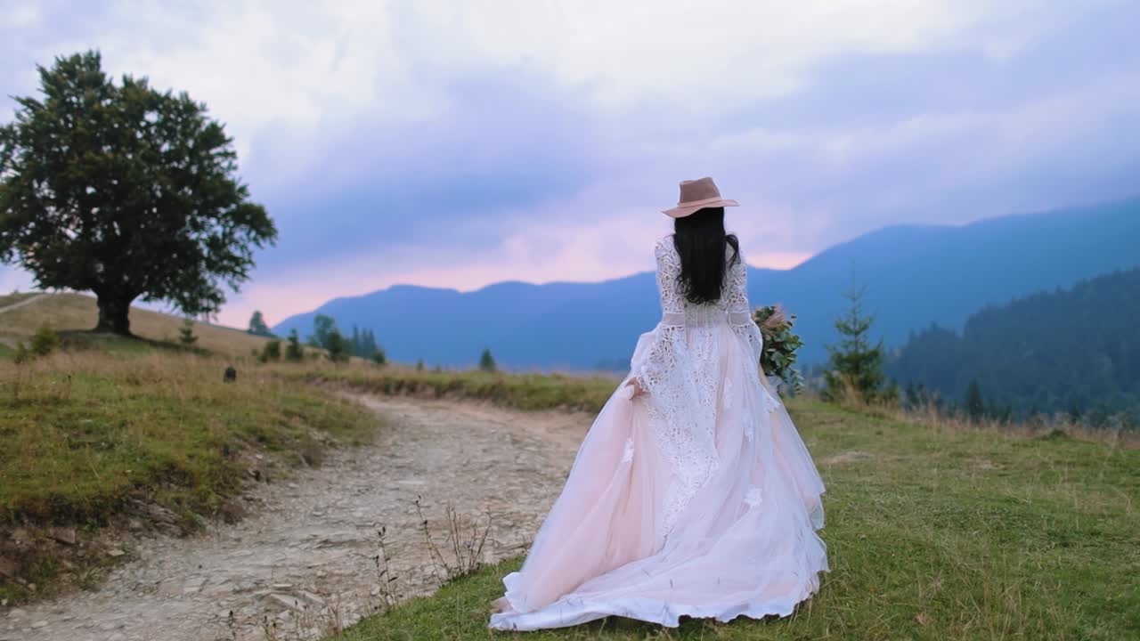 Bride on mountain hill. Beautiful young bride walking on the mountain hills