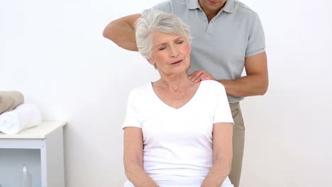 Physiotherapist-stretching-his-senior-patients-neck