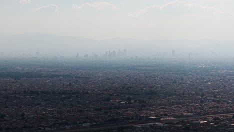 aerial telephoto drone footage of a heavily polluted, sprawling megalopolis