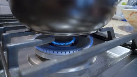 turn down the fire of gas stove range in kitchen