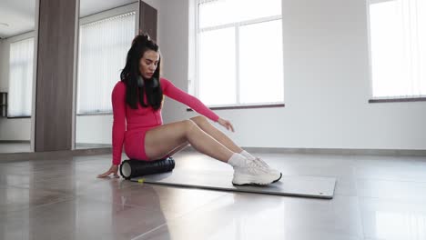 woman foam rolling at home
