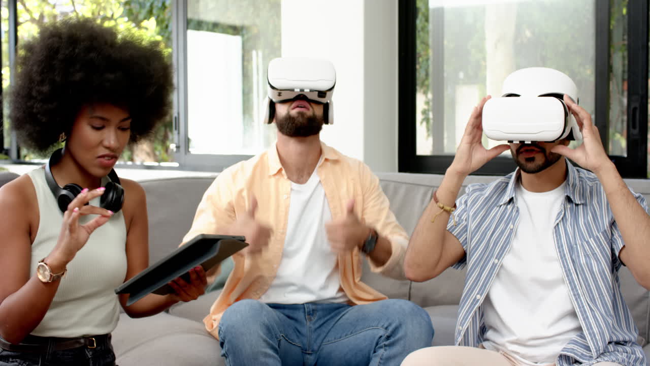 Using VR headsets, diverse friends experiencing virtual reality together on couch