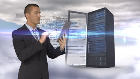 businessman using tablet computer in front of server tower on sky background