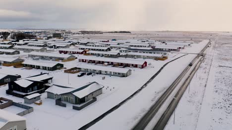 Cars-driving-on-road-of-Icelandic-city-in-winter-snow