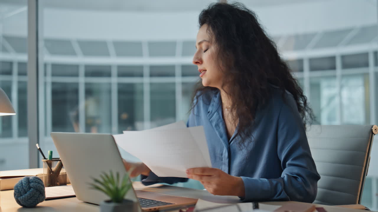 Boss arguing virtual meeting in office. Focused woman analyzing documents talk