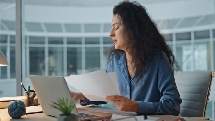 Boss arguing virtual meeting in office. Focused woman analyzing documents talk