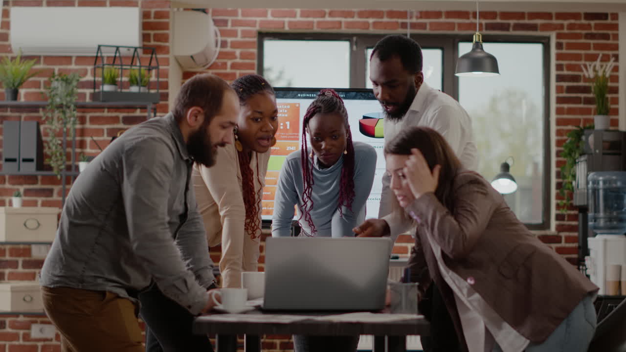 Team of workmates using laptop to plan business project