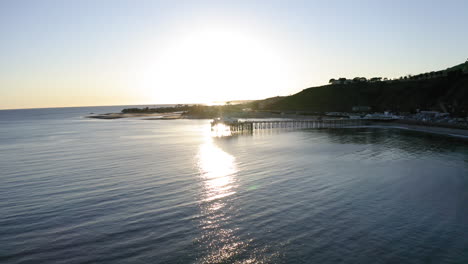 malibu pier at sunset with golden reflections on the pacific ocean