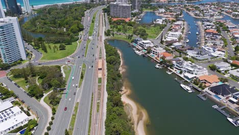 highway traffic near water and cityscape